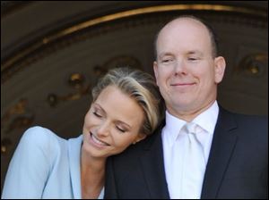 Prince Albert II of Monaco appears with his bride, Charlene, Princess of Monaco, at the Monaco palace, after the civil wedding marriage ceremony Friday.