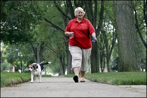 Professional pet sitter Marilyn Schnapp takes Zoe for a walk.