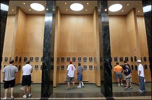 Patrons of the Baseball Hall of Fame and Museum view the plaques of inducted members during induction weekend July, 2010.