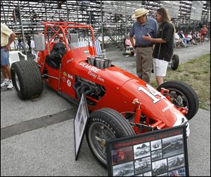 Clare Poremsky and Brian Dowell check out a car owned by Jerry Nemire and formerly driven by A.J. Foyt. Nemire was honored Friday night at Toledo Speedway.