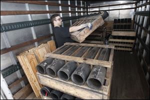 Jeremy Barbati loads a rack of tubes for fireworks into a truck that will leave a fireworks manufacturer in New Castle, Pa.