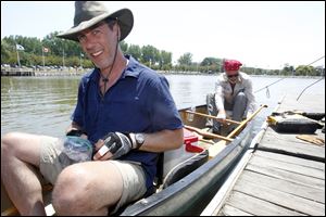 Matt Horvat, left, and canoe companion Steve Pollick, right, dock their canoe in International Park across from downtown Toledo on Friday.