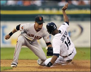 San Francisco Giants second baseman Emmanuel Burriss, left, loses the ball as Detroit Tigers' Austin Jackson steals second base in the sixth inning of an interleague baseball game Friday in Detroit. The Giants defeated the Tigers 4-3.