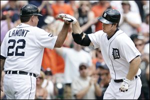 Detroit Tigers' Brennan Boesch, right, is congratulated by third base coach Gene Lamont after hitting a solo home run during the fourth inning of an interleague baseball game against the San Francisco.