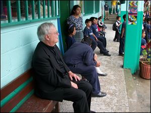 The Rev. Don Vettese joins students and staff at Francisco Coll school, built by International Samaritan, which he began as president of St. John's Jesuit High School.