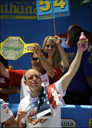 World Champion hot dog eater Joey Chestnut celebrates his win at the Famous Nathan's Hot Dog Eating contest, July 4, 2010.