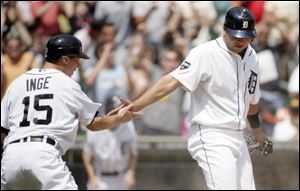 Detroit Tigers' Brandon Inge, left, and Jhonny Peralta celebrate after scoring on a single by Magglio Ordonez to take a 4-3 lead in the seventh inningagainst the San Francisco Giants. The Tigers won, 6-3.