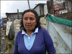 Alta Gracia, 46, says food she had found in the city dump and used to feed her children nearly killed her and her family. Now she earns a living working at a school. 