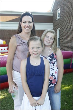 Anne Marie Hinkle, left,  enjoys  the Fourth of July party at the Inverness Club with her two daughters Addison Hinkle, 10, center and  Isabelle Hinkle, 12.