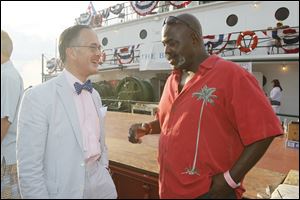The Blade publisher John Robinson Block shares a laugh with Mayor Mike Bell aboard the SS. Col. James M. Schoonmaker.