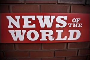 A News of the World sign hangs at the entrance to a News International building in London.