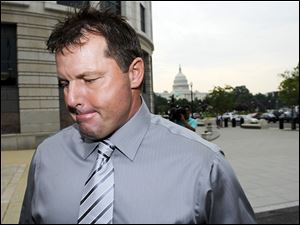 With the Capitol in the background, former Major League Baseball pitcher Roger Clemens arrives Wednesday at federal court in Washington.