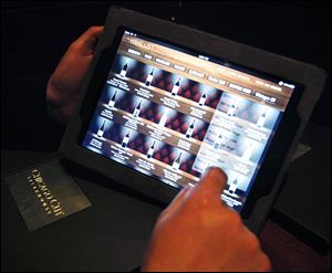 A patron navigates the wine list on an iPad at a Chicago steakhouse.
