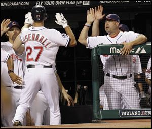 Cleveland Indians' Lonnie Chisenhall, left, is congratulated by manager Manny Acta after Chisenhall hit a solo home run off Yankees relief pitcher Boone Logan in the seventh.
