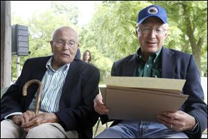 U.S. Rep. John Dingell, left, and Interior Secretary Ken Salazar look over the act that transfers the River Raisin National Battlefield Park to public ownership. 