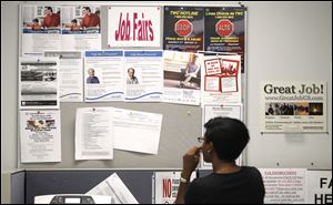 A job seeker looks at a bulletin at the Texas Workforce Commission's Workforce Solutions of Greater Dallas job resource center in Richardson, Texas, earlier this week.