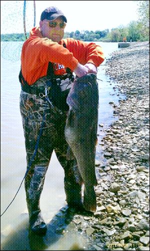 Angler Dondi 'DJ' Sturm has to use two hands to hold up this 63-pound flathead catfish.