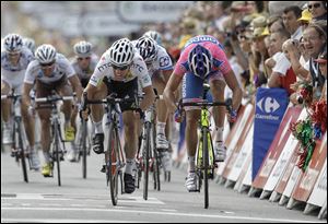 Mark Cavendish of Britain, center left, sprints to the finish line ahead of Alessandro Petacchi of Italy, right, to win the seventh stage of the Tour de France.