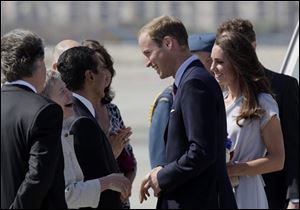 Prince William and Kate, the Duke and Duchess of Cambridge, are greeted by British Consul-General Dame Barbara Hay, second left, as they arrive at Los Angeles International Airport.