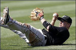 Toronto Blue Jays second baseman Aaron Hill looks up after diving for a ball hit by Cleveland Indians' Grady Sizemore during the seventh inning Sunday.