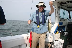 David Mustine shows a Lake Erie walleye he caught aboard Sea Breeze Sixteen during the 33rd annual Governor’s Fish Ohio Day promotion in Port Clinton.