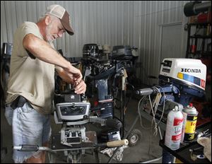Dennis Schlegel works on a boat motor at Bi-State Marine Service in Erie, Mich. Local marinas say older boats are not as equipped as newer models to deal with the ethanol which is added to gasoline.