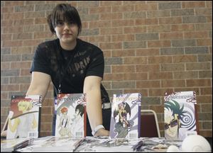 Halah Mohamed, 19,  displays her self-published manga novels at this year's Glass City Con.