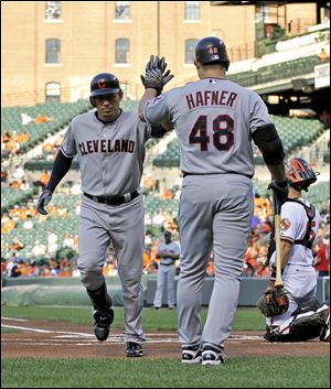Cleveland Indians' Asdrubal Cabrera, left, high-fives teammate Travis Hafner after hitting a solo home run during the first inning of a baseball game against the Baltimore Orioles, Thursday, July 14, 2011, in Baltimore. (AP Photo/Gail Burton) 
S6 15s6asdrubal 2.93