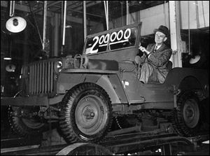 Ward M. Canaday, chairman of the board for Willys-Overland, drives the 200,000th Jeep built in Toledo during World War II off the assembly line in this April 4, 1944, file photo.