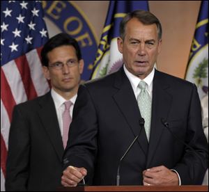 House Speaker John Boehner of Ohio, right, speaks Friday during a news conference with House Majority Leader Eric Cantor, R-Va., on Capitol Hill in Washington.