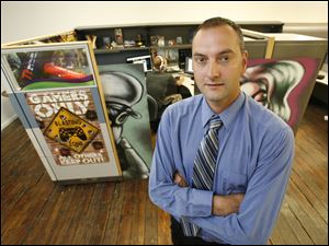 Tony Legeza, foreground, who co-founded Beyond Gaming in Toledo with Justin Yamek, background, says he would like to see a centralized hub with resources for business start-ups.