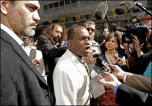 NFL player Association executive director DeMaurice Smith along with NFL Payers Association president Kevin Mowae, left, speaks to reporters outside a law firm where contract talks ended.