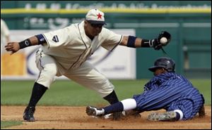 Chicago White Sox runner Juan Pierre, right, safely steals second under the tag of Detroit Tigers second baseman Carlos Guillen Saturday.