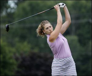 Helene Beat focuses on the ball after teeing off on No. 13 at Valleywood Golf Club in Swanton en route to winning the Toledo Women’s District Golf Association title.