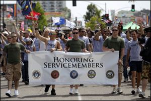 More than 200 active duty troops and war veterans waving small American flags alongside rainbow banners marched in San Diego's gay pride parade in what is believed to be the first time an identifiable group of active duty troops has participated in such an event in the United States.
