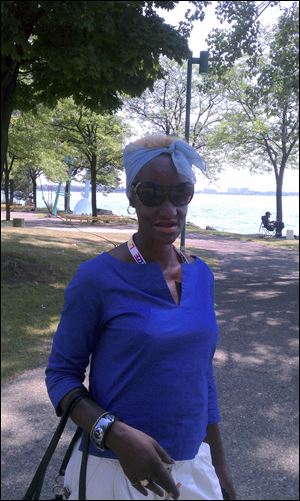Michelle Nealis seeks the shade of Chene Park on the
Detroit River.