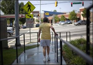 An elderly Atlanta resident uses a newly constructed ramp.