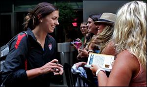 Alex Morgan greets fans after she and other members of the U.S. soccer team arrived in New York's Times Square on Monday.