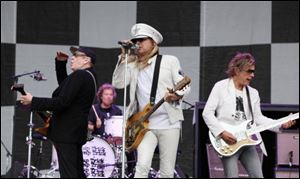 From left to right, Rick Nielsen, Bun E. Carlos, Robin Zander and Tom Petersson of the band Cheap Trick perform at the Cisco Ottawa Bluesfest on Sunday before the stage collapsed. Three people were hospitalized. the band's truck driver was among the injured.