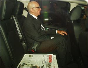 Rupert Murdoch leaves his London home Monday. Murdoch and his son James Murdoch are to be grilled by a parliamentary committee of British lawmakers Tuesday