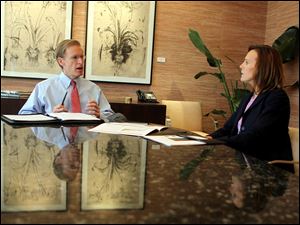 Ray Stranghoener, left, president of the Commerce Trust Co., a unit of Commerce Bank, discusses strategy with Vice President Cathleen Arshadi. The bank has added services and staff to its  Family Office this year to serve 75 families who have more than $25 million in assets not including their houses. 