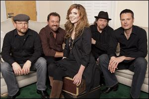 Alison Krauss, center, poses with Union Station, from left, Ron Block, Dan Tyminski, Krauss, Jerry Douglas, and Barry Bales.