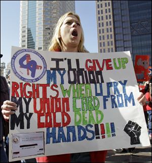 Christine Sancrant, 34, a pipefitter from Toledo, voices her opinion at a rally against SB-5 outside the Statehouse during the State of the State speech by Gov. John Kasich in March.