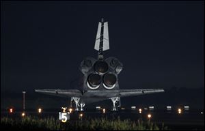 Space Shuttle Atlantis comes to a complete stop at the Kennedy Space Center landing strip.