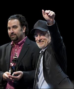Steven Spielberg, right, stands on stage with Comic-Con programming director Eddie Ibrahim during the panel for 