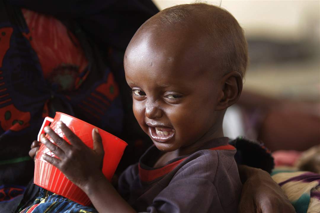 Kenya-child-red-cup-grin