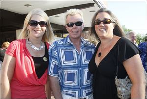 Julie Mizerek, from left, Brian Bahrs, and Denise Blissard attend Party in the Parking Lot at the Toledo Club.