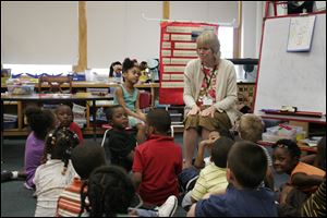 Teacher Christine Hopkins leads a kindergarten class at VanDuyn Elementary School in Syracuse, N.Y. Say Yes officials say that students need to be in the program from kindergarten to graduation to get the full impact. 