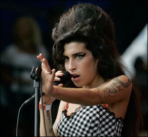 British singer Amy Winehouse performs at Lollapalooza at Grant Park in Chicago in 2007. The Grammy-winning soul diva was found dead in her London home on Saturday.