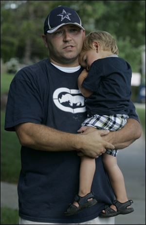 Scott Schultz holds his son, Tyler, whom he saved from being abducted Friday evening.